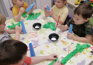 Dzieci wykonujące pracę plastyczną choineczki.