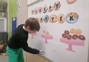 Dzieci przeliczające pączki.