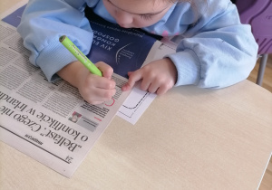 Dziewczynka szukająca litery w tekście.