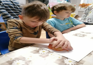 Dzieci stęplują jabłkiem maczanym w farnie