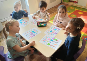 Dzieci przy stolikach grają w BINGO