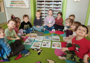 na dywanie przed planszami przedstawiającymi pracę dentysty