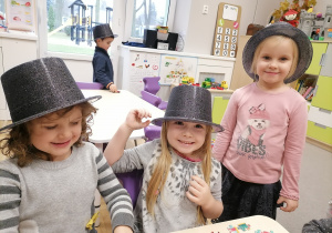 Trzy dziewczynki w brokatowych kapeluszach.