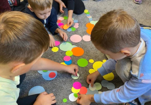 Dzieci układają różne kształty z rożnej wielkości kropek.