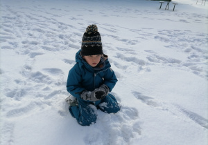 Dziecko bawiące się śniegiem.