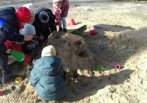 Dzieci bawiące się w piaskownicy.