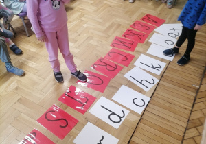 Dzieci wskazujące literki wskazane przez nauczyciela.