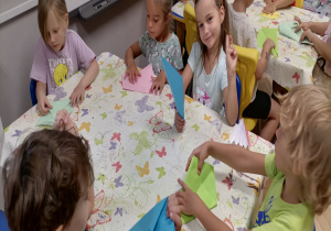 Dzieci składają latawce z papieru