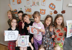 Dieci pozują do zdjęcia na tle dyniowej dekoracji