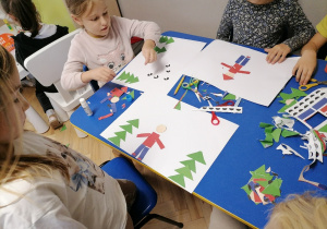 Dzieci wyklejają obrazki z figur geometrycznych